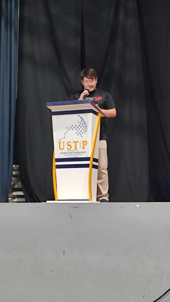 Jonathan Seet speaking at the close of a 2025 overseas learning expedition