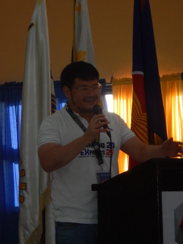 Jonathan Seet delivering a thank-you speech into a microphone at an event